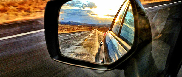 Rear view of a road from side mirror.